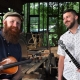 Josh Goforth holding banjo & Bryan McDowell holding fiddle